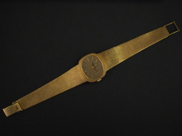 OMEGA Montre bracelet, boiter et bracelet en or jaune. Cadran à bord a