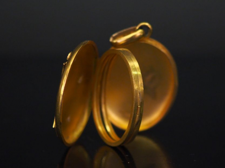 Pendentif porte-photo de forme ovale en or jaune, à décor appliqué de 