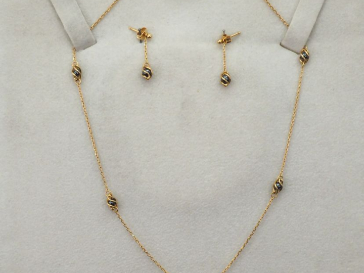 Demi-parure en or jaune agrémentée de perles grises. Comprenant :  - u