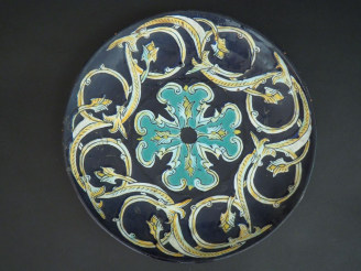 Vente aux enchères Coupe sur talon en terre vernissée et émaillée à décor de rinceaux ver