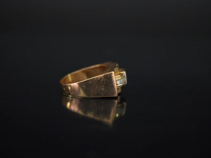 Bague tank en or jaune, sertie en son centre d'une pierre rose épaulée