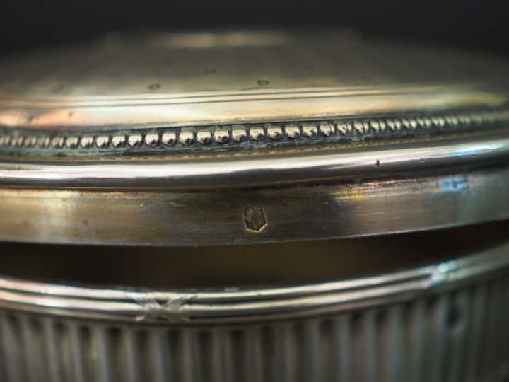 Ensemble comprenant :  - une boite ronde de style Louis XVI en argent,