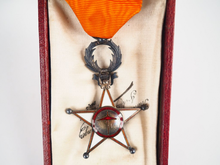 Boite d’origine contenant sur fond crème une étoile de l’ordre marocai