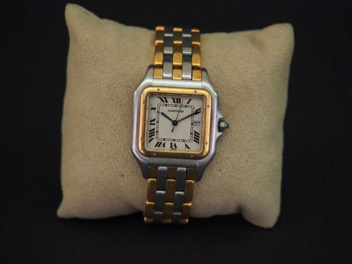 CARTIER.  Montre "Panthère", boîtier et bracelet en or jaune et acier.