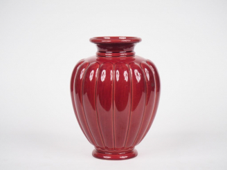 Vente aux enchères Vase ovoîde en céramique rouge à décor de godrons. Signé sous la base.