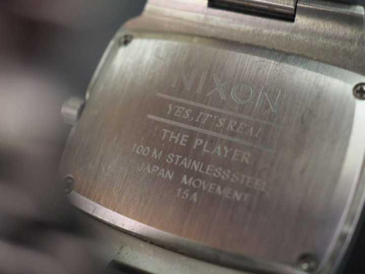 NIXON,  Montre bracelet en acier.  Cadran rectangulaire à fond noir ag