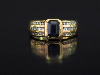 Vente aux enchères Bague moderne en or jaune, sertie en son centre d'une pierre bleue.  L