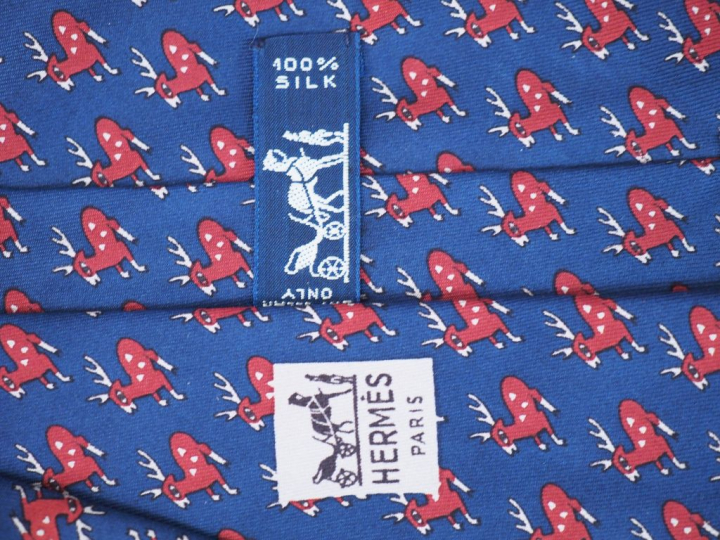 HERMES, Paris Deux cravates en soie.  L'une à décor de cervidés rouge 