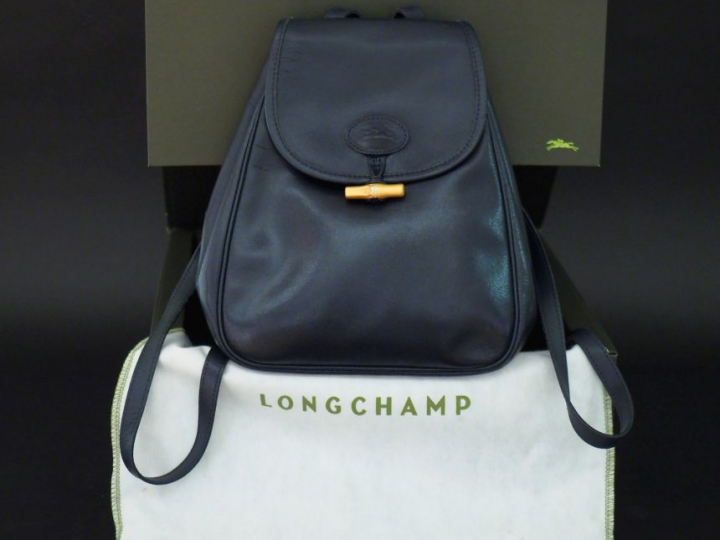 LONGCHAMP,  Sac à dos en cuir bleu marine.  Fermeture à rabat et press
