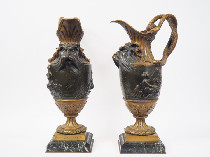 CLODION (d'après).  Paire d'aiguières en bronze patiné, à décor de mas