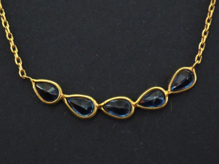 Collier en or jaune 750, maille forçat, orné en son centre d’une suite