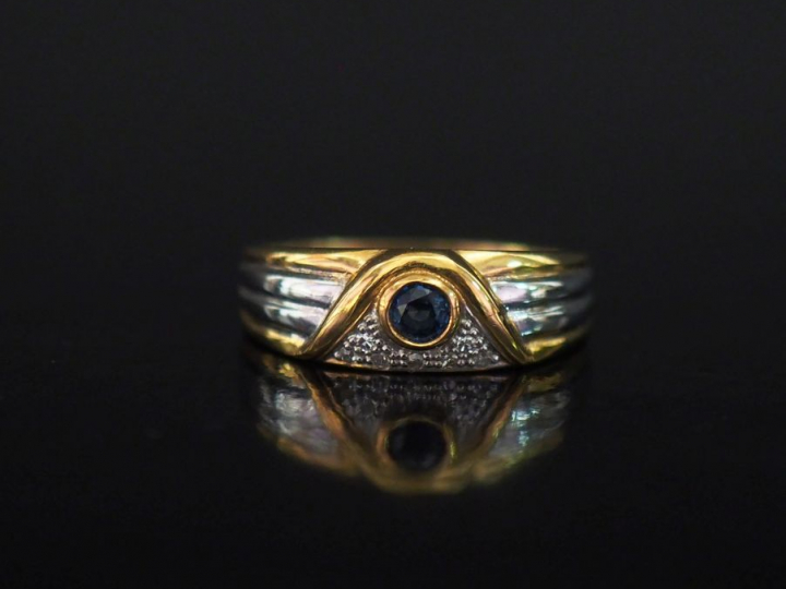 Bague deux tons d'or 750, sertie d'une pierre bleue et d'un pavage de 