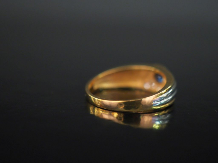 Bague deux tons d'or 750, sertie d'une pierre bleue et d'un pavage de 