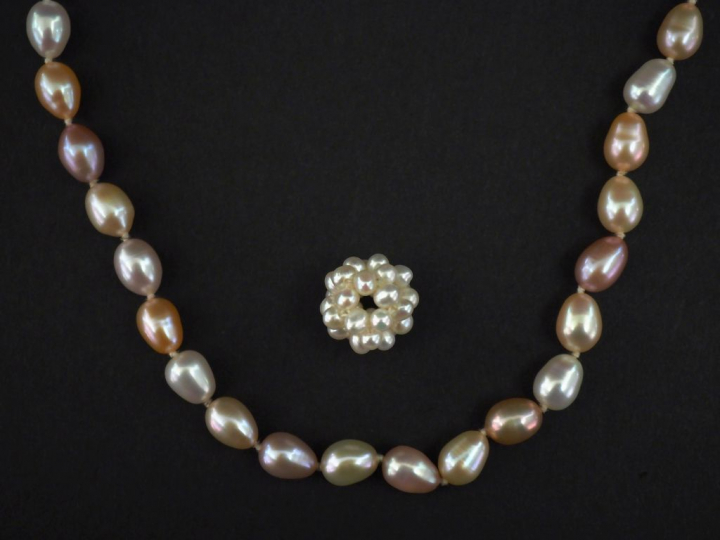 Ensemble comprenant :  - un pendentif ajouré en perles blanches et un 