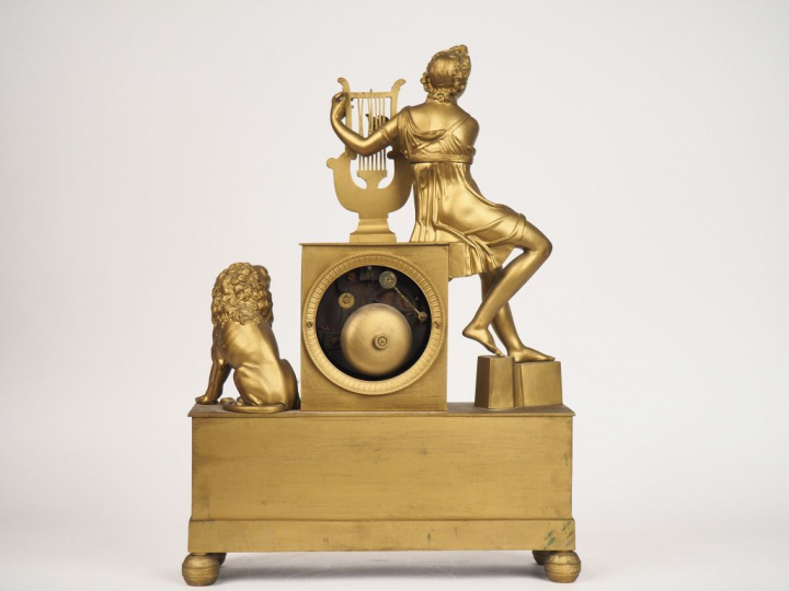 Pendule Restauration en bronze repatiné et doré, à décor d'Apollon et 