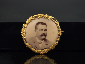 Vente aux enchères Petite broche ronde en or jaune 750, à décor de guirande de branchage 
