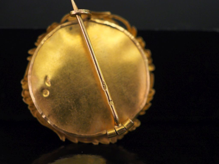Petite broche ronde en or jaune 750, à décor de guirande de branchage 