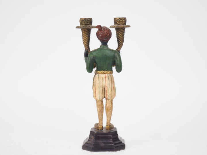 Candélabre en métal polychrome figurant un jeune nubien, éclairant à d