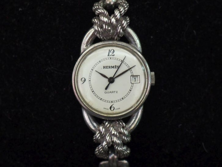 HERMES,  Montre bracelet de dame en argent 925.  Cadran rond à chiffre