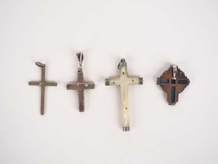 4 différentes croix en métal argenté, nacre, verroterie et émail. H. d