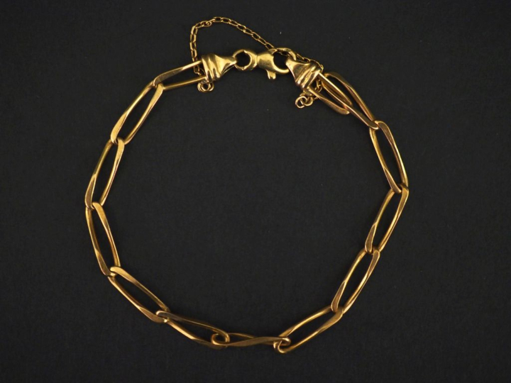 Bracelet souple en or jaune 750, maille cheval.  Chainette de sécurité