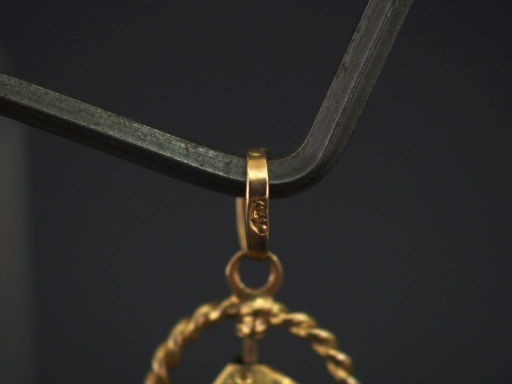 Petit pendentif en or jaune 750, à décor d'un dé en pendeloque.  Diam.