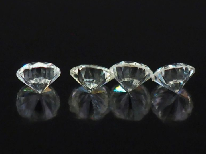 Ensemble comprenant quatre diamants sur papier pesant chacun 0,2 ct en