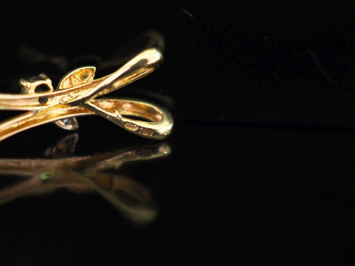 Ensemble comprenant :  - un pendentif de forme stylisée en or jaune 75