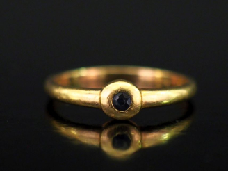 Vente aux enchères Petite bague en or jaune 750, ornée en son centre d'une pierre noire s