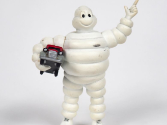 Vente aux enchères MICHELIN. Bibendum, sujet en plastique rigide tenant un camion rouge d