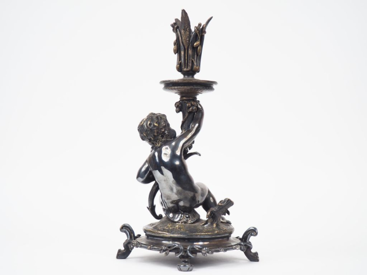 CHRISTOFLE.  Bougeoir en bronze argenté "Amour présentant une corne d'