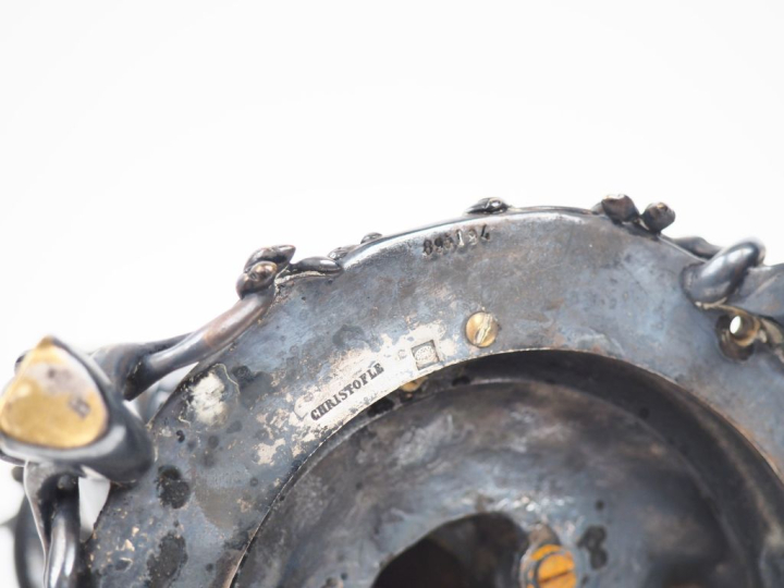 CHRISTOFLE.  Bougeoir en bronze argenté "Amour présentant une corne d'