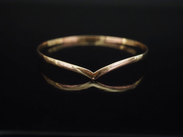 Bracelet jonc de forme stylisé en or jaune 750.  Diam. 7 cm Poids. 10,