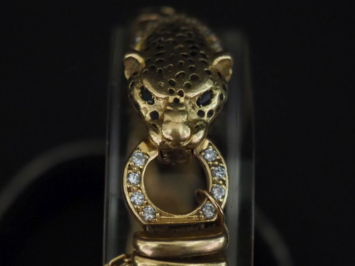 Bracelet souple en or jaune 750, maille américaine, à décor d'une tête