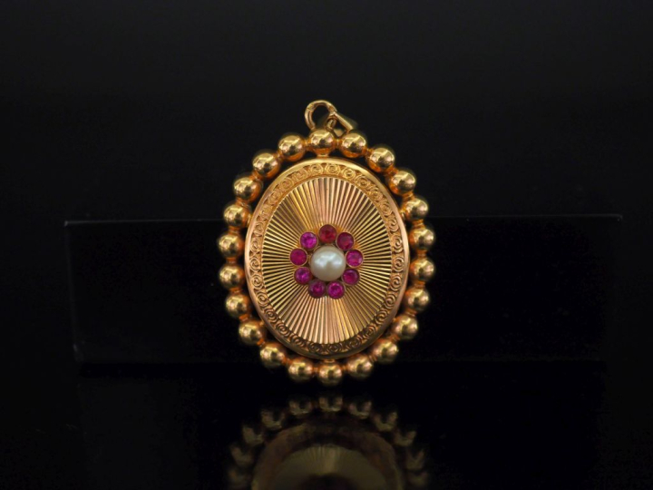 	Pendentif ovale en or jaune 750, à décor en son centre d’un motif de 