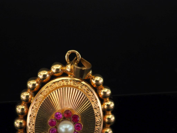 	Pendentif ovale en or jaune 750, à décor en son centre d’un motif de 