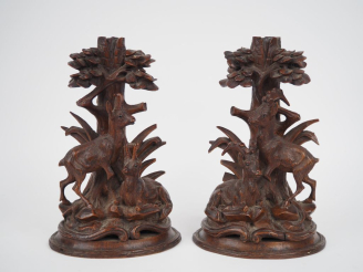 Vente aux enchères Paire de bougeoirs fin XIXème en chêne sculpté à décor de chamois et d