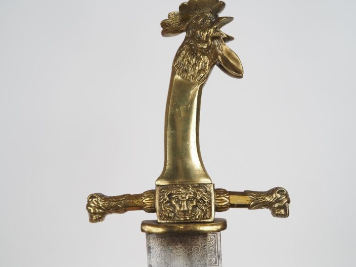 Fort glaive de sapeur.  Poignée en bronze, à pans, à tête de coq hurla