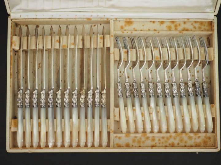 Suite de douze couteaux et fourchettes à dessert en métal argenté, man