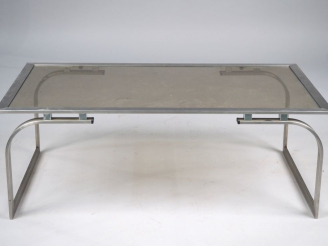 Vente aux enchères Table basse 1970 en métal chromé, plateau en verre fumé. Dim. 35 x 96 