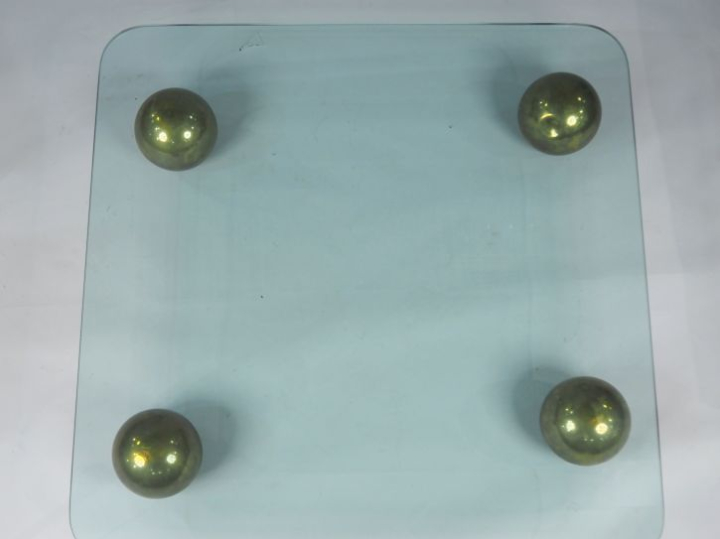 Table basse, pieds en forme de boule en laiton, plateau verre.  Dim. 1