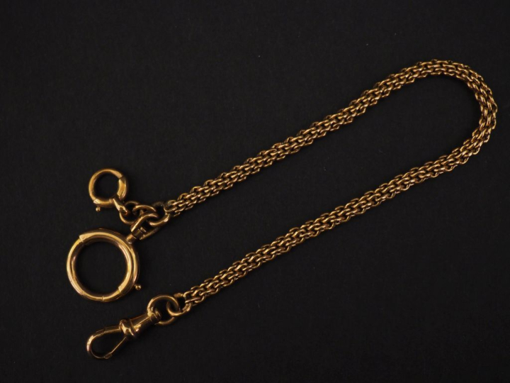 Petite giletière en or jaune 750, maille ronde tressée.  Long. 17,3 cm