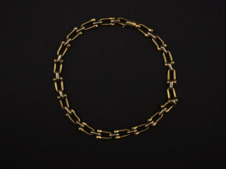 Vente aux enchères Bracelet deux tons d'or 750, à décor de poulies.  Long. 18,7 cm Poids.