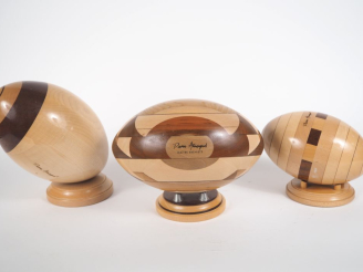 Vente aux enchères Pierre ARMENGAUD.   Trois ballons de rugby en marqueterie.