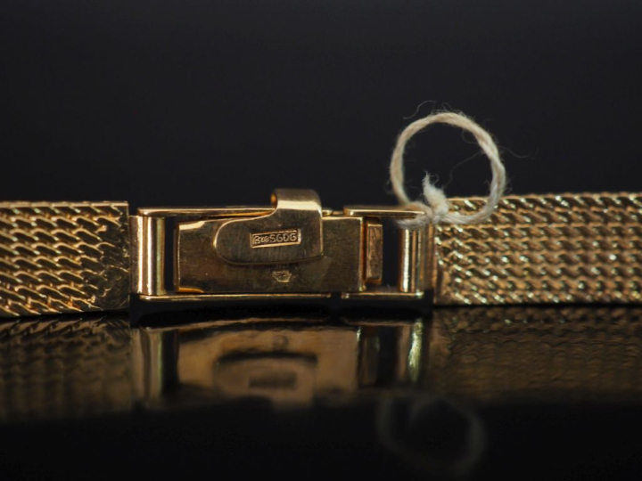 Bracelet de montre en or jaune 750, maille plate articulée.  Long. 14,