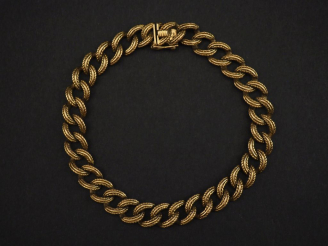 Vente aux enchères Bracelet souple en or jaune 750, maille gourmette stylisée. Long. 21,2