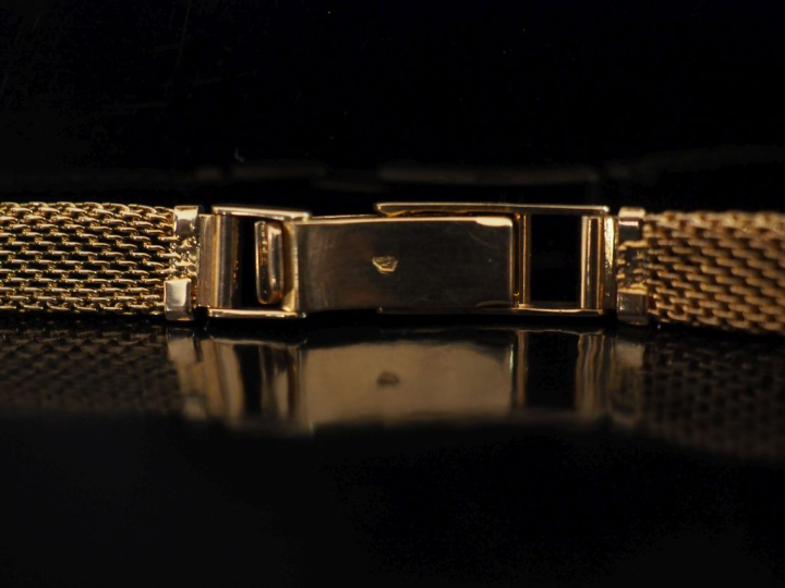 Bracelet de montre en or jaune 750, maille plate tressée.  Long. 13,5 
