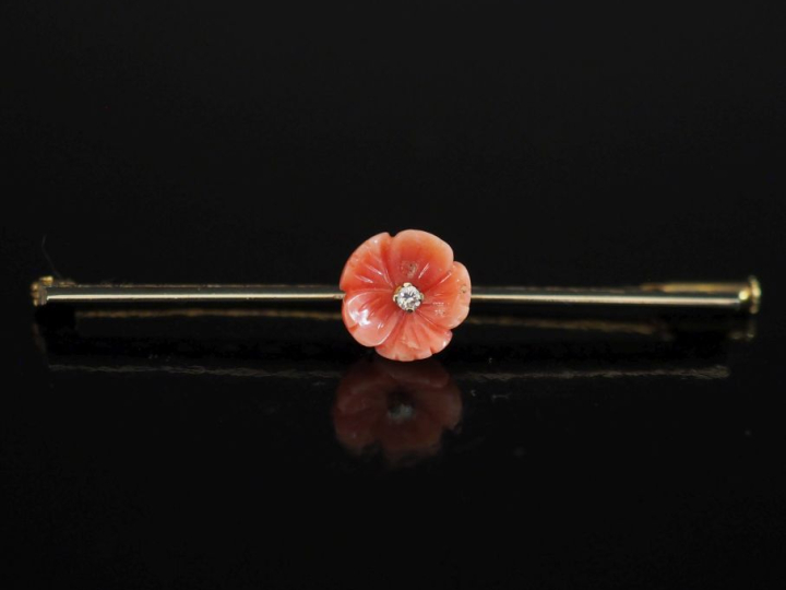 Broche barrette en or jaune 750, ornée en son centre d'une fleur imita
