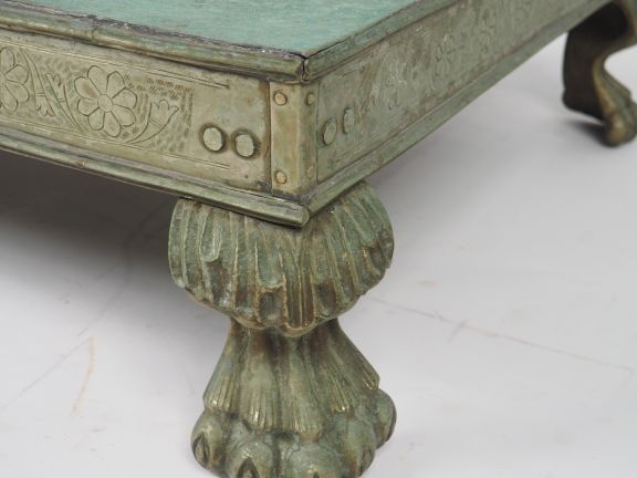 Table basse indienne en métal patiné vert, orné de quatre pieds griffe