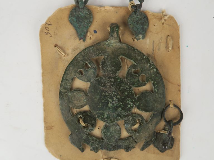 Bronzes antiques. Une plaque ajourée à décor de peltes, une poignée et